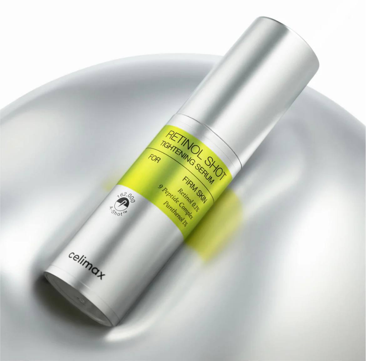 Пляшечка сироватки Celimax The Vita-A Retinol Shot Tightening Serum лежить на м'якій поверхні.